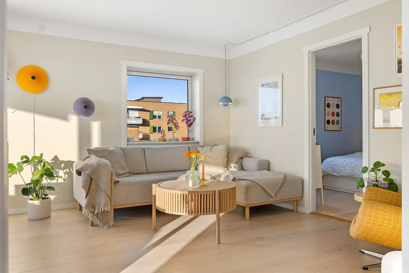 A bright living space with a sofa, natural textures, and generous windows
